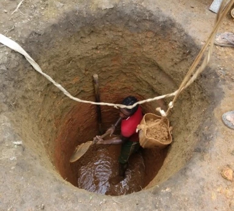 A man digging a well by hand