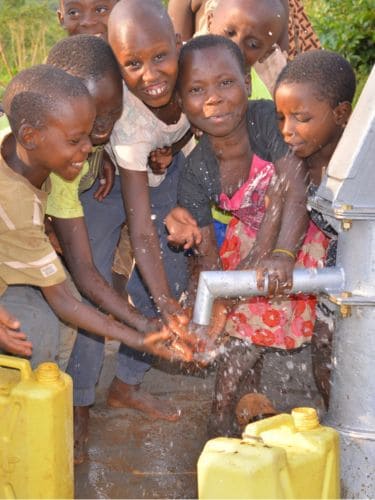 Kids enjoying a new water well